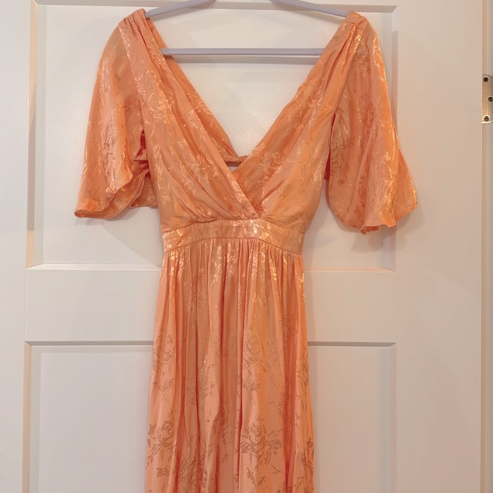 Brand New Size 4 Peach Dress.  Ties in back and cut low with  butterfly sleeves.